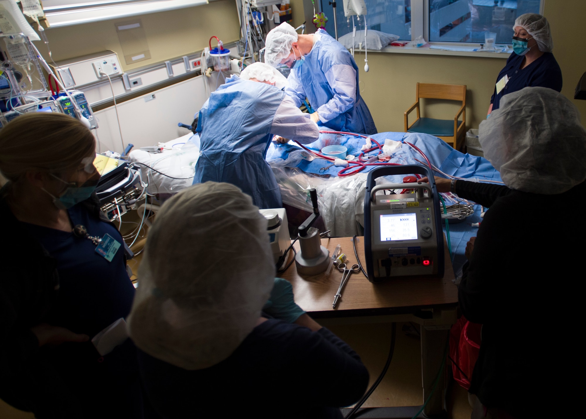 Members of the 59th Medical Wing Extracorporeal Membrane Oxygenation transport team connect a patient to an ECMO system for transport from Lafayette General Medical Center to San Antonio Military Medical Center, Joint Base San Antonio-Fort Sam Houston, Texas, April 20. ECMO is a heart-lung bypass system that circulates blood through an external artificial lung and sends it back into the patient’s bloodstream. (U.S. Air Force photo/Staff Sgt. Kevin Iinuma) 