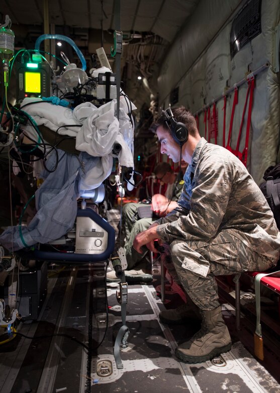 Capt. Jeffrey Dellavolpe, 959th Medical Operations Squadron critical care physician, regulates the Extracorporeal Membrane Oxygenation system during a flight to San Antonio Military Medical Center, Joint Base San Antonio-Fort Sam Houston, Texas, April 20. ECMO is a heart-lung bypass system that circulates blood through an external artificial lung and sends it back into the patient’s bloodstream. (U.S. Air Force photo/Staff Sgt. Kevin Iinuma)
