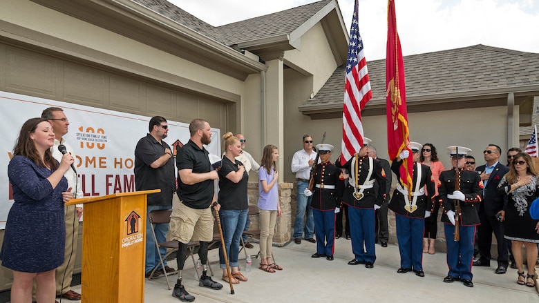 Alyssa Beach sings the national anthem at Cpl. Jonathan Dowdell's dedication ceremony in League City, Texas, April 14, 2016. The home dedication marks Operation FINALLY HOME’s 100th dedication for a deserving veteran or surviving spouse.