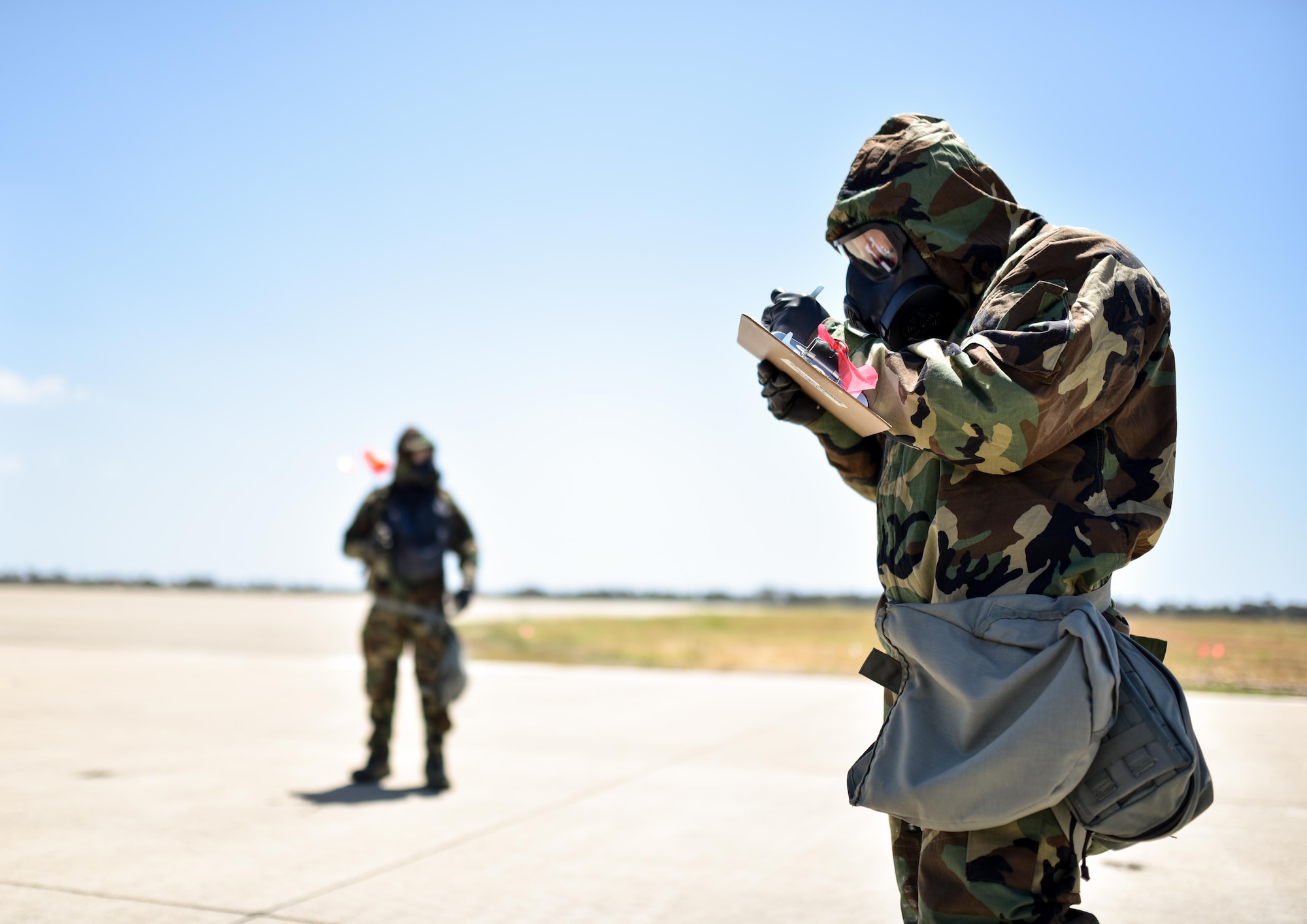 U.S. Air Force Airman 1st Class Jeremy Flores (front) and Senior Airman Samuel Gordon (back,) both assigned to the 433rd Airlift Control Flight, Joint Base San Antonio-Lackland, Texas, coordinate in marking the locations of mock unexploded ordnance as part of a chemical warfare exercise during Patriot Hook, Los Alamitos Army Airfield, California April 23, 2016. The 433rd Airlift Control Flight is serving as the lead agency. Other participating Air Force Reserve units include the 452nd Air Mobility Wing at March Air Reserve Base, California, the 439th Airlift Wing from Westover Air Reserve Base, Massachusetts, and the 315th ALCF from Joint Base Charleston, South Carolina. (U.S. Air Force photo by Senior Airman Steven A. Ortiz/Released) 
