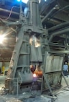 A large hammer forge at SIFCO Industries in Cleveland uses tons of pressure to form metal into high-strength military parts.