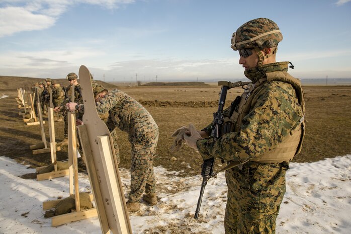 U.S. Marines with Black Sea Rotational Force review their shot groups as they zero their individual weapon during a live-fire exercise aboard Mihail Kognalniceanu Air Base, Romania, Feb. 2, 2016. Marines from 1st Battalion, 8th Marine Regiment, conducted battle sight zeroes on various individual weapons systems, to prepare for future BSRF exercises and contingencies. (U.S. Marine Corps photo by Cpl. Kelly L. Street, 2D MARDIV COMCAM/Released)