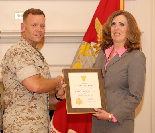 Brig. Gen. Joseph Shrader, commander of Marine Corps Systems Command, presents a certificate to Jeannette Evans-Morgis during her Senior Executive Service Appointment Ceremony April 21 at Harry Lee Hall aboard Marine Corps Base Quantico, Virginia. Upon her selection to the SES in December 2015, Evans-Morgis assumed responsibility as chief engineer of the Marine Corps and deputy commander for Systems Engineering, Interoperability, Architectures and Technology at Marine Corps Systems Command. (U.S. Marine Corps photo by Mathuel Browne)
