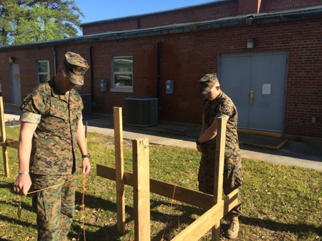On April 18, 2016 Second Lieutenants Justin Wilkison and Troy Searcy, Marines attached to Combat Engineer Officer course 5-16 (CEO 5-16); use a plumb bob to establish building lines and to ensure a building is level during vertical construction. Plumb bobs are a tool that date back to Ancient Egypt.
