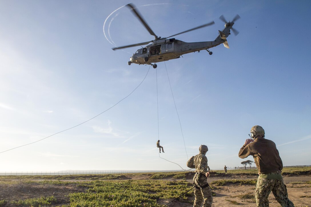 A sailor rappels from an MH-60S Seahawk helicopter during rope suspension training in Imperial Beach, Calif., April 21, 2016. Navy photo by Seaman Kelsey L. Adams