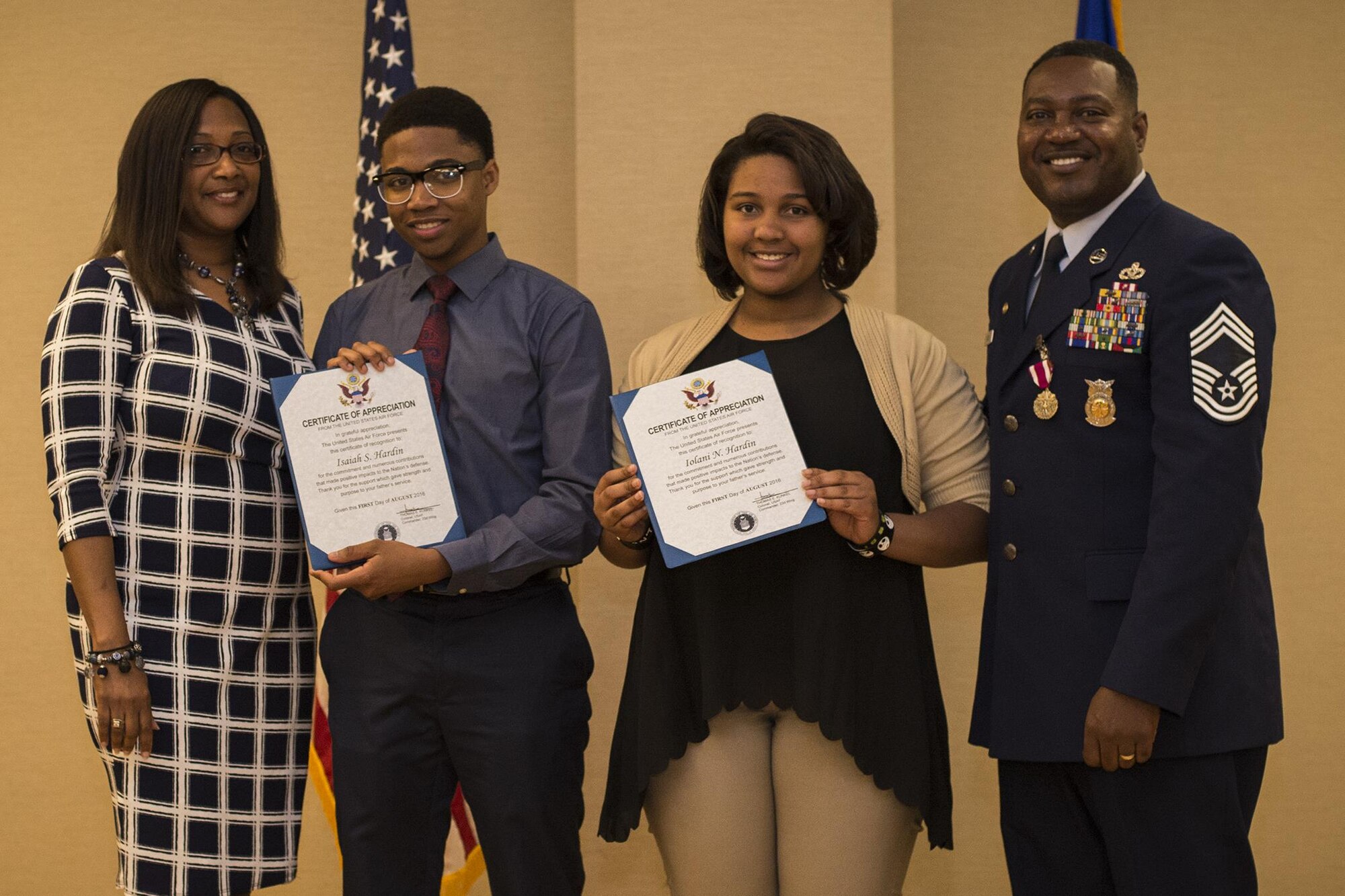 U.S. Air Force Chief Master Sgt. Will Hardin Jr. and his wife, Nicole, present their children, Isaiah and Iolani, with certificates of appreciation, April 22, 2016, at Moody Air Force Base, Ga. The 23d Civil Engineer Squadron surpassed Air Force response standards by three percent under Hardin’s management. (U.S. Air Force photo by Airman Daniel Snider/Released)