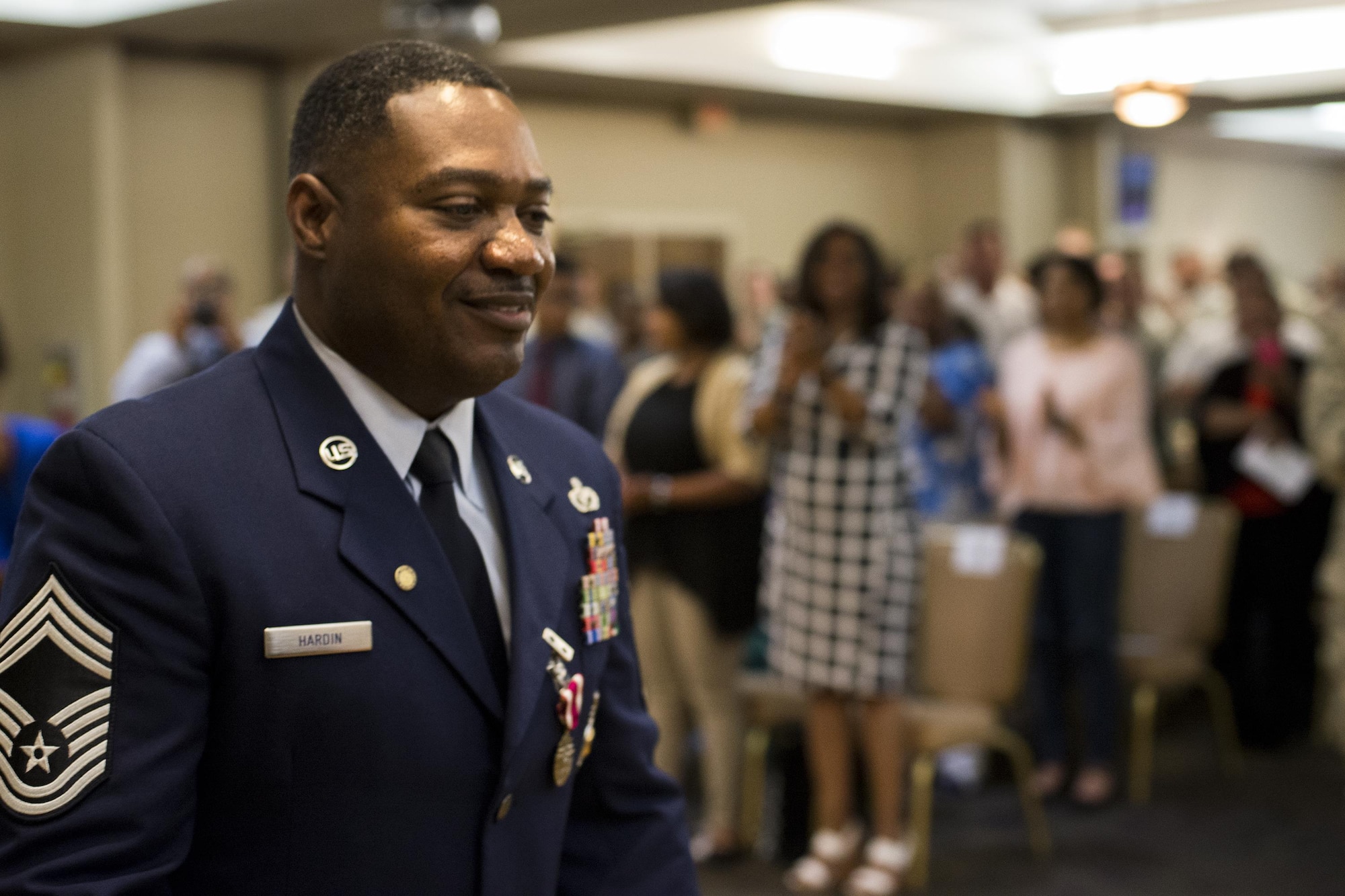 U.S. Air Force Chief Master Sgt. Will Hardin Jr. receives a standing ovation during his retirement ceremony, April 22, 2016, at Moody Air Force Base, Ga. Hardin led 227 military and 100 civilians during his time as fire chief for the 23d Civil Engineer Squadron. (U.S. Air Force photo by Airman Daniel Snider/Released) 
