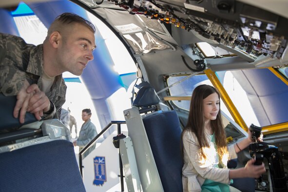 Master Sgt. Joseph Hubbs, 434th Maintenance Operations Flight production controller, explains the controls of a KC-135R Stratotanker interactive flight deck to Melea Morgan at the 2016 Indiana Woman Veterans’ Conference in Indianapolis, April 15, 2016. The event was held to bring awareness to women veterans and also provide information about VA benefits available to them. (U.S. Air Force photo/Tech. Sgt. Benjamin Mota)