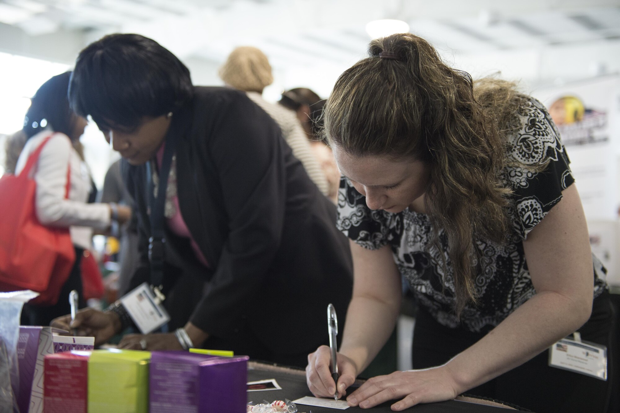 Tech. Sgt. Erica Sherwood, 434th Force Support Squadron NCOIC, and Senior Master Sgt. Linda Mason-Wilson, 434th Operational Support Squadron first sergeant, fill out cards to win cosmetics during the 2016 Indiana Woman Veterans’ Conference in Indianapolis, April 15, 2016. During the event participants visited a variety of workshops and stations setup to provide information and benefits.  (U.S. Air Force photo/Tech. Sgt. Benjamin Mota)