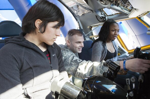 Master Sgt. Joseph Hubbs, 434th Maintenance Operations Flight production controller, explains the controls of a KC-135R Stratotanker interactive flight deck to, left, Senior Airman Viridiana Munoz, 434th Operations Support Squadron aircrew flight equipment specialist, and Airman 1st Class Ivy Richardson, 434th Maintenance Squadron personalist, at the 2016 Indiana Woman Veterans’ Conference in Indianapolis, April 15, 2016. During the event participants visited a variety of workshops and stations setup to provide information and benefits.  (U.S. Air Force photo/Tech. Sgt. Benjamin Mota)