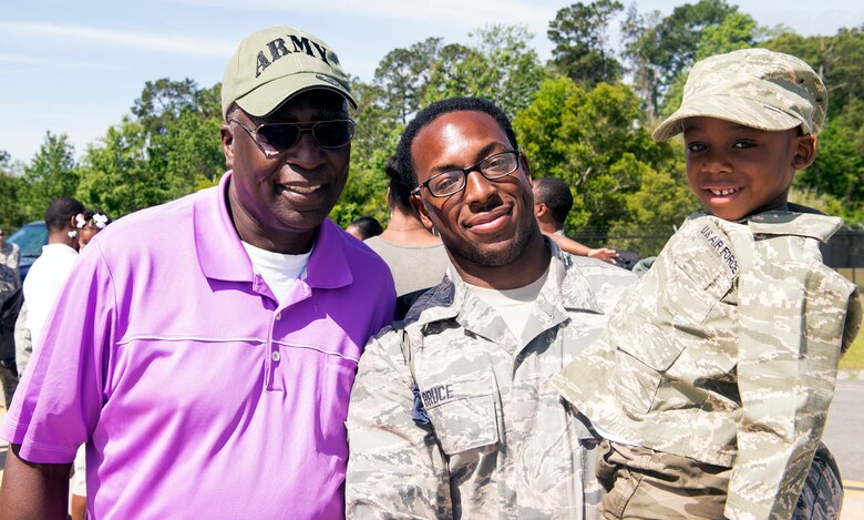 U.S. Air Force Airman 1st Class Aubree Bruce, 23d Equipment Maintenance Squadron aircraft armament systems specialist, center, poses with his dad, retired U.S. Army Maj. Irvin Campbell, left, and his son, Khalen, during a redeployment in support of the 75th Fighter Squadron, April 22, 2016, at Moody Air Force Base, Ga.  More than 250 Airmen supported the 75th FS while deployed. (U.S. Air Force photo by Airman 1st Class Greg Nash/Released) 