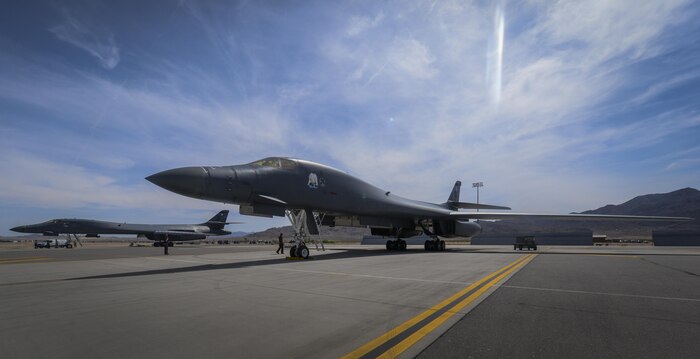 Two B-1B Lancers, assigned to the 34th Bomb Squadron, Ellsworth Air Force Base, South Dakota, sit on the bomber pad before takeoff during Green Flag 16-05 at Nellis Air Force Base, Nev., April 21, 2016. Airmen who are new to their position gain from Green Flag the repetitions and fundamental close air support training necessary to be successful when emerged in a deployment environment. (U.S. Air Force photo by Airman 1st Class Kevin Tanenbaum)