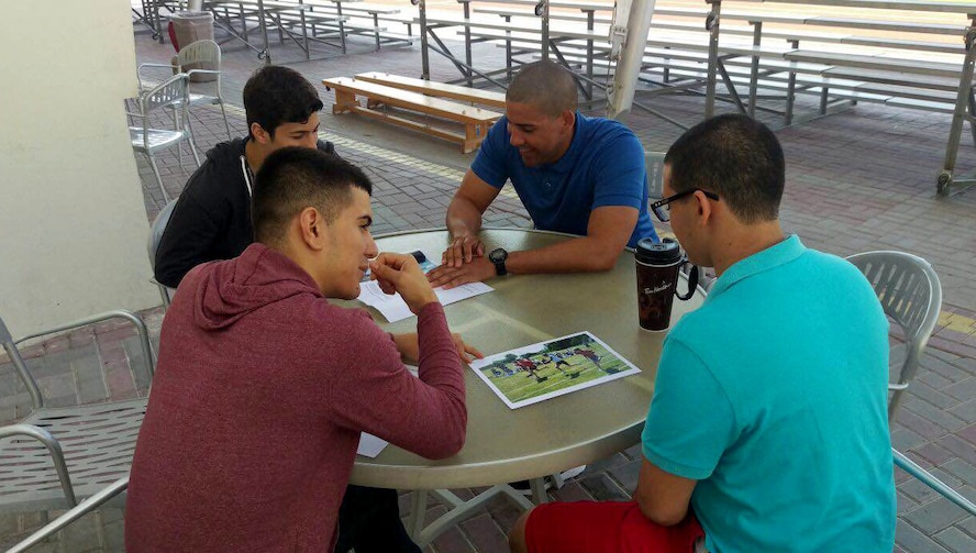 Senior Manuel Medrano (front left), 419th Logistics Readiness Squadron, preps high school students for a Spanish test at an American school outside his deployed location in Southwest Asia. Medrano and fellow reservist Senior Airman Daniel Gomez-Moyado have volunteered their off-duty time on weekends to tutor teens in Spanish speaking and comprehension skills. (Courtesy photo)