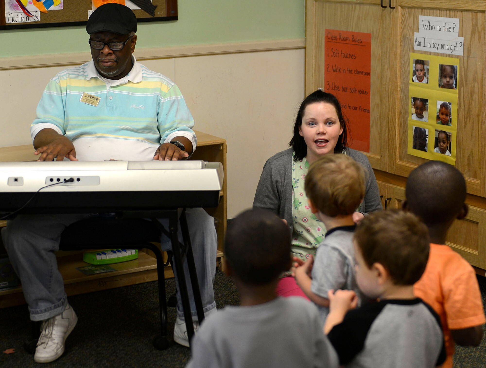 Latrell Woods, 20th Force Support Squadron Child and Youth Services transportation coordinator (left,) and Julie Denton, 20th FSS CYS training and curriculum specialist (right,) sing with toddlers during a Month of the Military Child spirit week at the 20th FSS Chandler Cornell Child Development Center at Shaw Air Force Base, S.C., April 14, 2016. The CDC provides a variety of age-appropriate programs for children ages 6-weeks to 5-years. (U.S. Air Force photo by Airman 1st Class Christopher Maldonado)