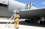 ANDERSEN AIR FORCE BASE, Guam (April 20, 2016) - Firefighters with the 36th Civil Engineer Squadron practice egress training on a KC-135 Stratotanker on the flightline during an operational readiness exercise.  Egress training involves learning how to enter an aircraft to rescue any personnel on board should they become incapacitated during an emergency situation. 