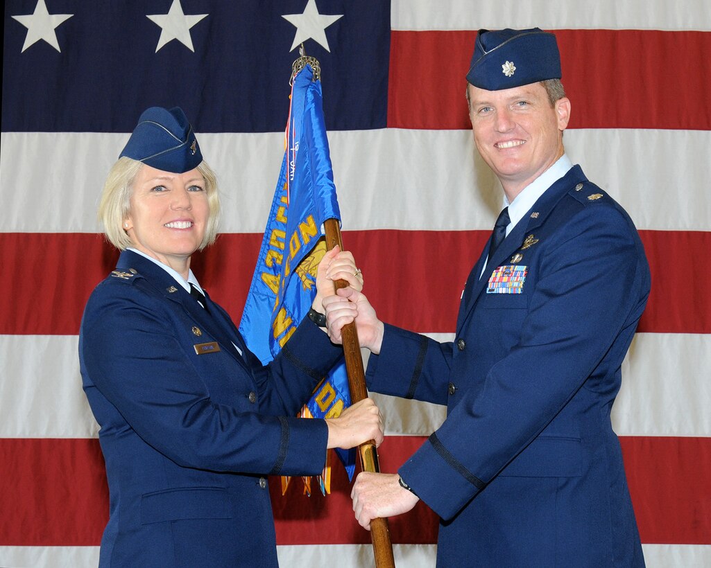 Col. Charlan Poirson, 340th Flying Training Group Commander, Randolph Air Force Base, Texas, passes the 43rd Flying Training Squadron guidon to Lt. Col. Brent Drown, the new 43rd FTS Commander, during a change of command ceremony April 22 at Columbus Air Force Base, Mississippi. (U.S. Air Force photo/Melissa Doublin)