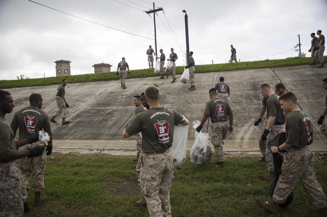 Marines with Marine Corps Support Facility New Orleans, Marine Forces Reserve remove litter along the levee in New Orleans, Louisiana on Earth Day, April 22, 2016, after a volunteer event run by the Single Marines Program. Each year, the program hosts a “Day in Service,” in which Marines and sailors dedicate their day to volunteering in their local community.