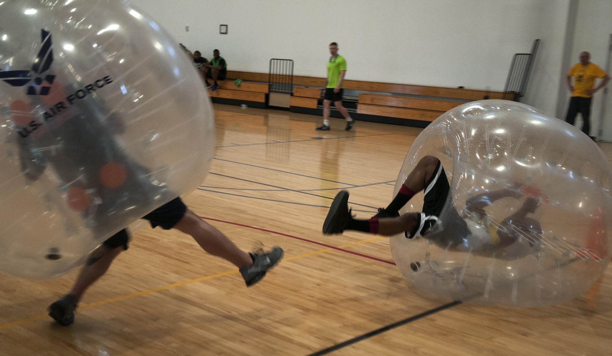 Two Airmen ricochet away from one another April 22, 2016, after colliding during a bubble soccer Tournament in the Freedom Hall Fitness Center on F.E. Warren Air Force Base, Wyo. Though scoring a goal was the overall objective, utilizing the bubbles to push opponents out of the way helped score. (U.S. Air Force photo by Senior Airman Brandon Valle)