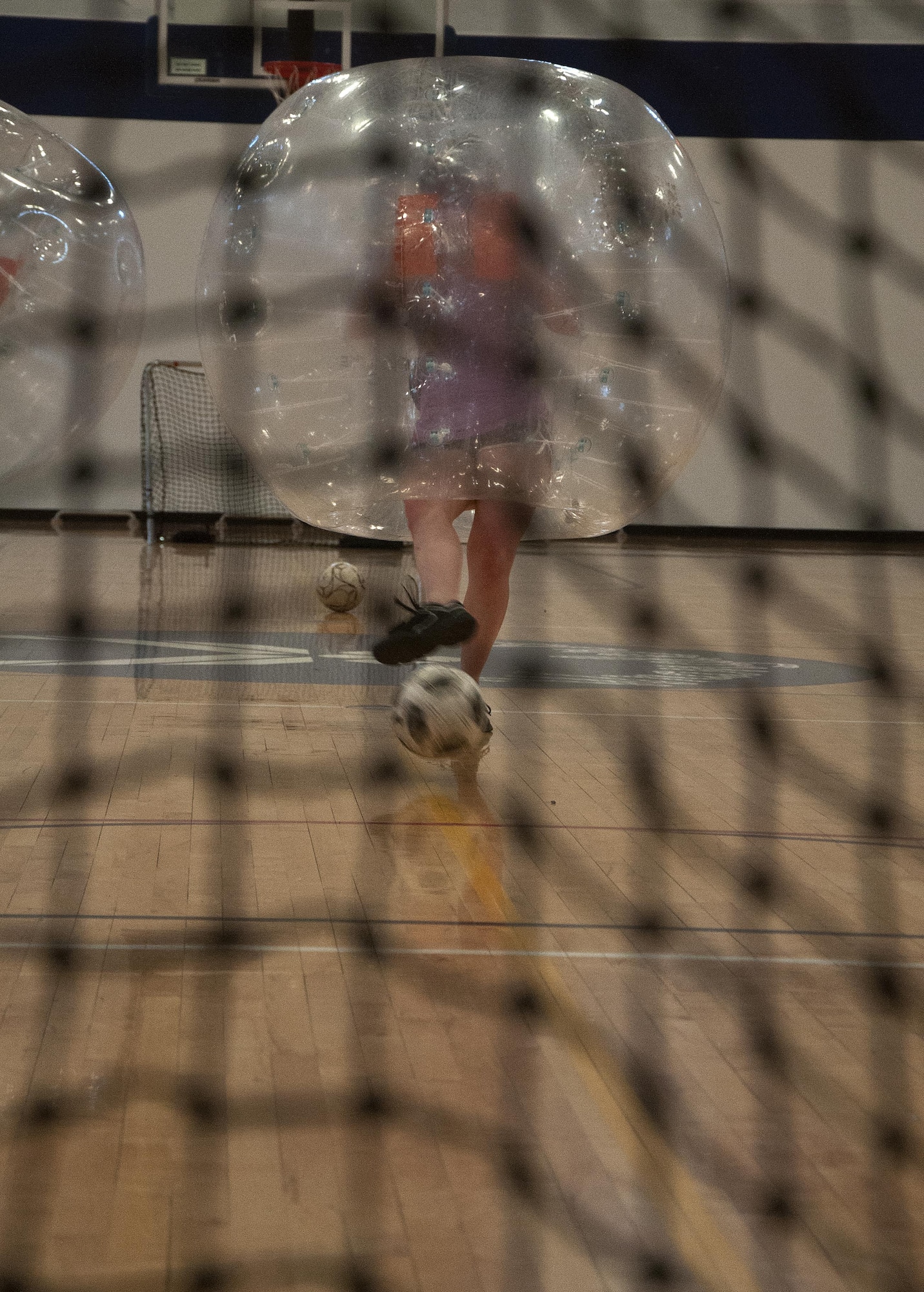 Emily Kiesel shoots a soccer ball towards the goal April 22, 2016, during a bubble soccer Tournament in the Freedom Hall Fitness Center on F.E. Warren Air Force Base, Wyo. In the event of a tie, both teams sent one player to duel for the goal. (U.S. Air Force photo by Senior Airman Brandon Valle)