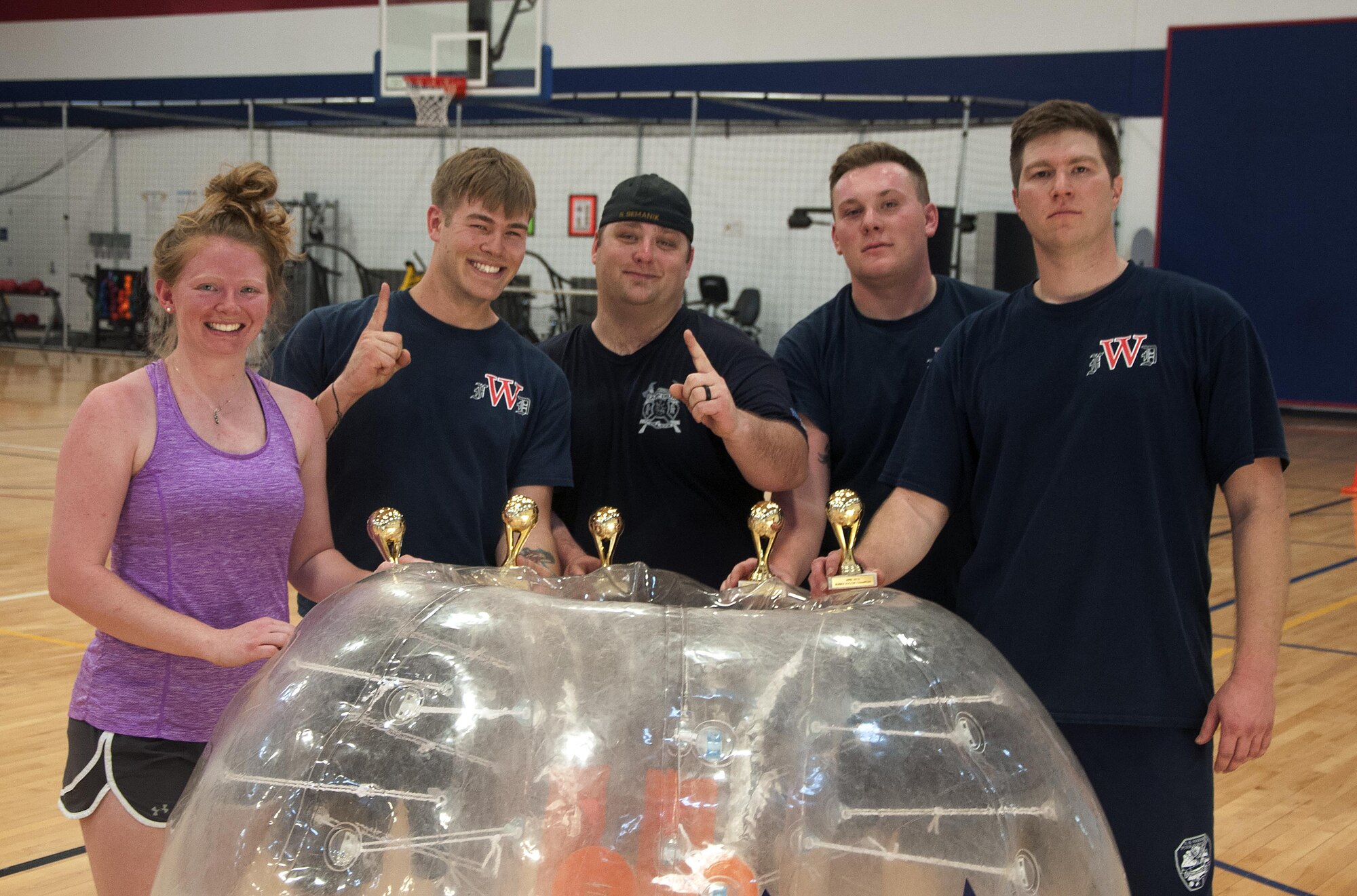 The team from the 90th Civil Engineer Squadron Fire Department pose after winning the championship of a bubble soccer tournament inside the Freedom Hall Fitness Center on F.E. Warren Air Force Base, Wyo., April 22, 2016. The team went undefeated through five games to claim victory. (U.S. Air Force photo by Senior Airman Brandon Valle)
