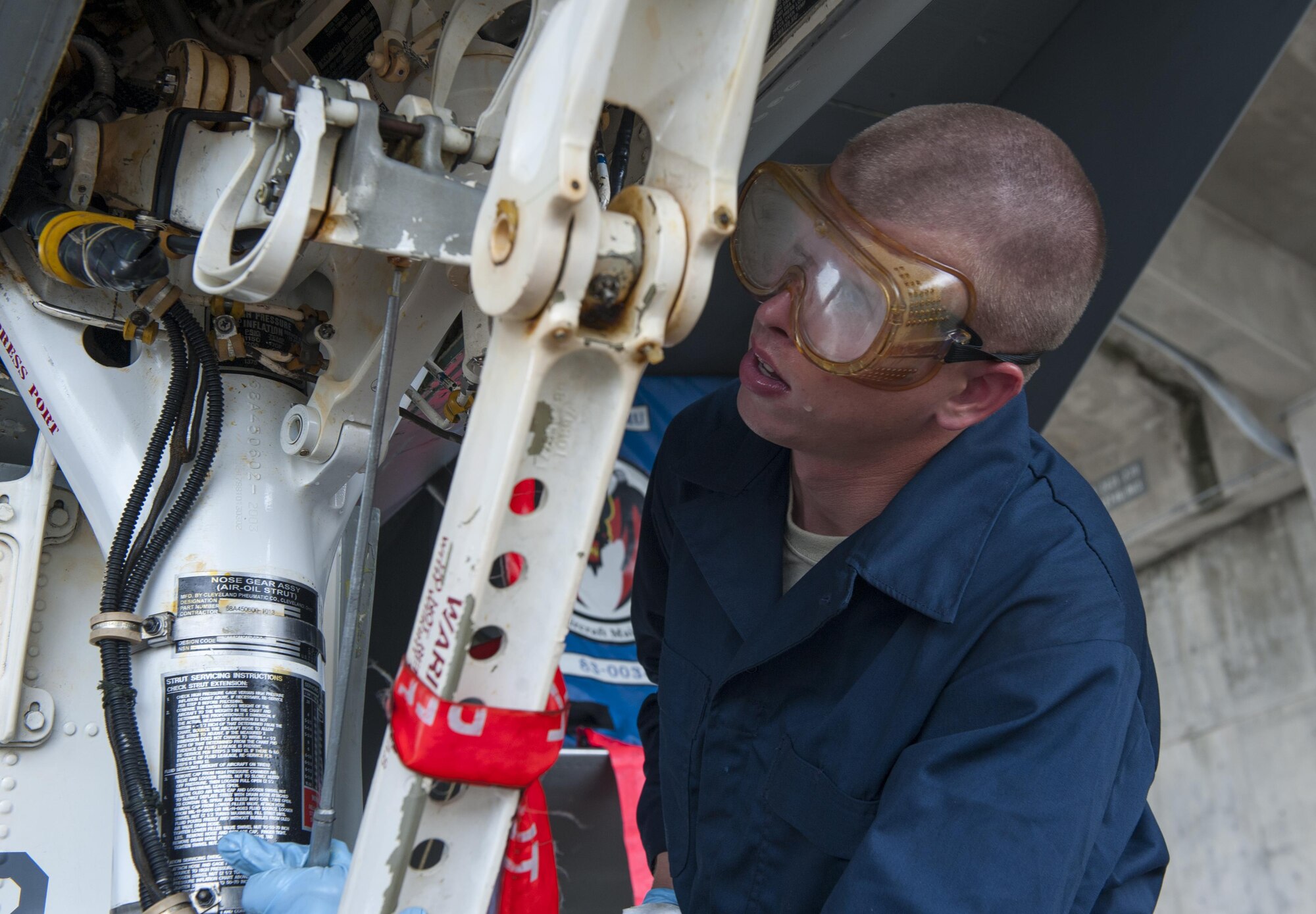 U.S. Air Force Airman 1st Class Brandon Meyer, 44th Aircraft Maintenance Unit crew chief, uses an aircraft lubricant to ensure all moving parts are operational at all times, April 26, 2016, at Kadena Air Base Japan. This maintenance is performed every thirty days when the F-15C Eagles are washed. (U.S. Air Force photo by Airman Zackary A. Henry)