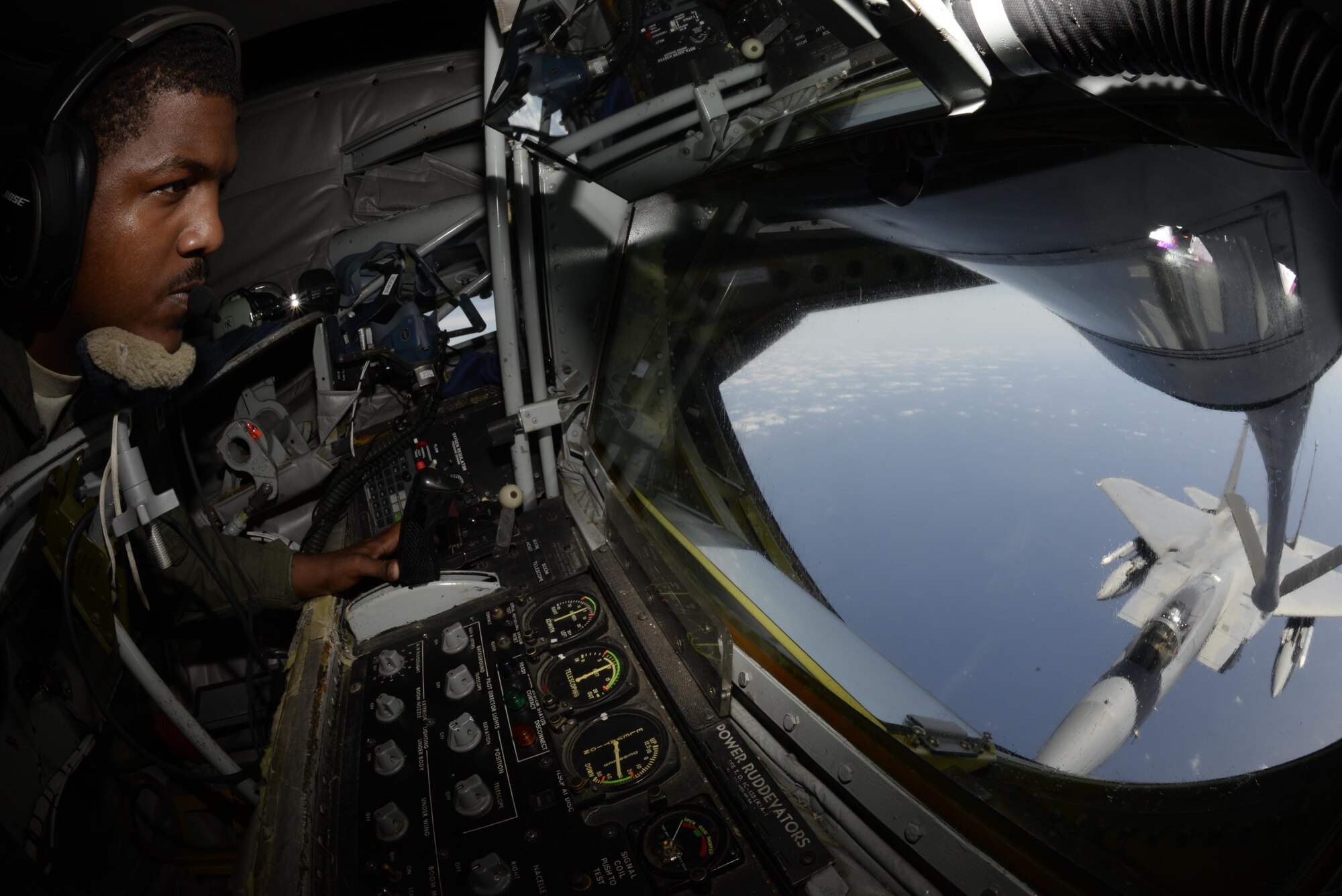 U.S. Air Force Airman 1st Class Cory Drummond, 909th Aircraft Refueling Squadron boom operator, refuels an F-15C Eagle during a refueling mission April 20, 2016, near Kadena Air Base, Japan. The 909th ARS invited Kadena’s honorary commanders to observe the refuelling in order to showcase the 18th Wing’s mission and capabilities.. (U.S. Air Force photo by Senior Airman Stephen G. Eigel)