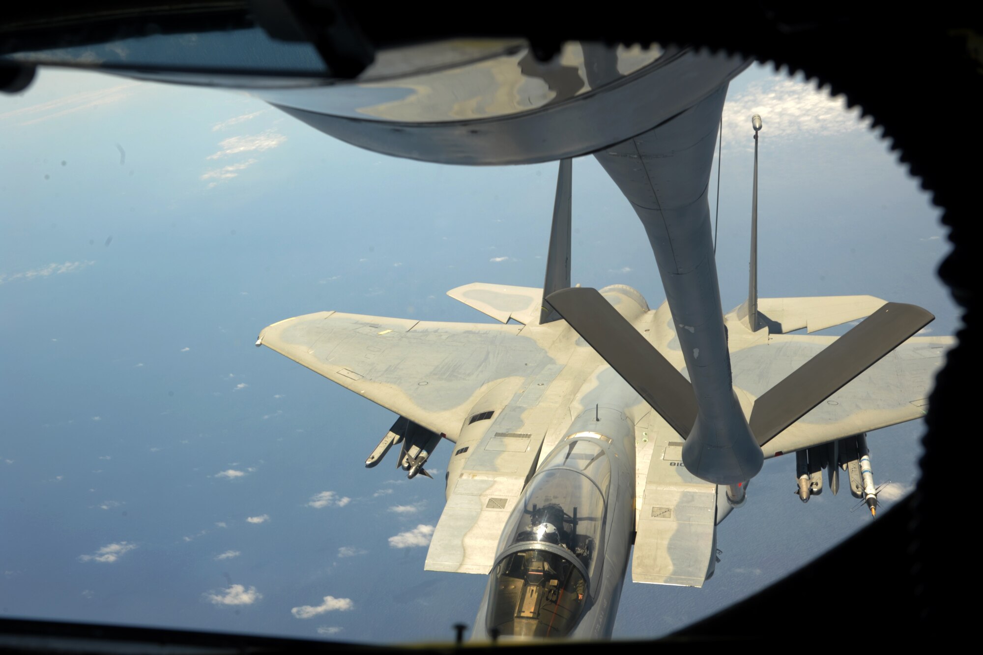 A U.S. Air Force KC-135 Stratotanker maneuvers into position above an F-15C Eagle during a refueling mission April 20, 2016, near Kadena Air Base, Japan. The 909th Air Refueling Squadron provides combat-ready KC-135 tanker aircrews to support peacetime operations and all levels of conflict in the Indo-Asia-Pacific theater. (U.S. Air Force photo by 1st Lt. Virginia Lang/Released)