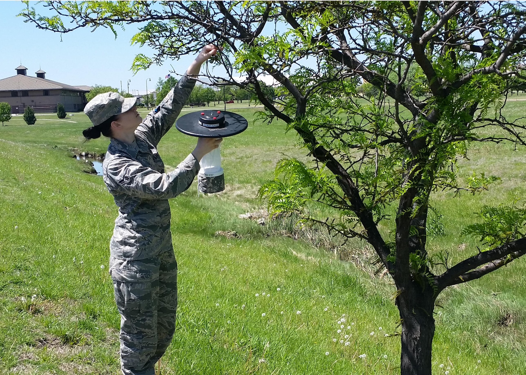 Airman 1st Class Meghara Pralle, 22nd Medical Group public health technician, sets up a mosquito trap, April 22, 2016, at McConnell Air Force Base, Kan. Culex mosquitoes, which carry West Nile Virus, are prevalent in most regions of Kansas and are a continued medical risk. (Courtesy photo)   