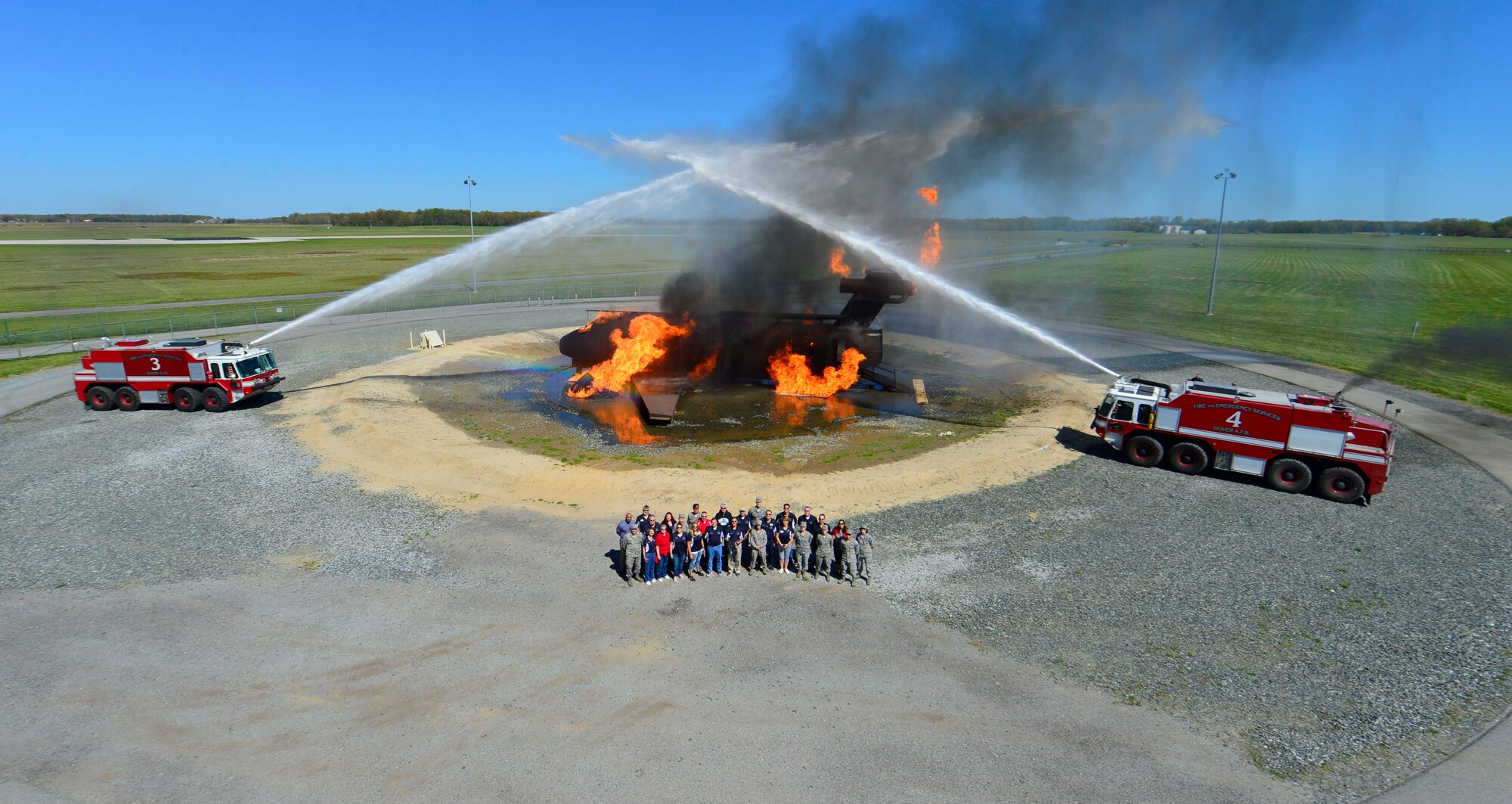 Team Dover Honorary Commanders and Airmen pose for a photo at the fire training facility April 20, 2016, at Dover Air Force Base, Del. The honorary commanders spent the day touring and seeing the missions of various squadrons within the 436th Mission Support Group. (U.S. Air Force photo/Senior Airman William Johnson)