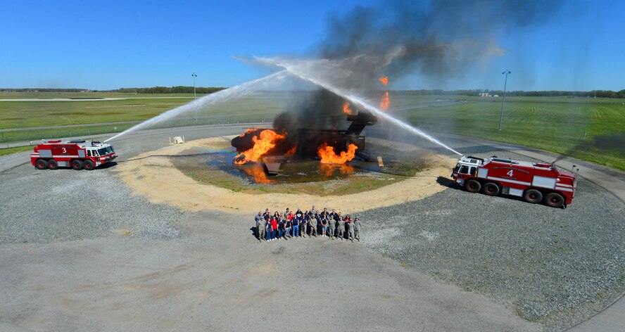 Team Dover Honorary Commanders and Airmen pose for a photo at the fire training facility April 20, 2016, at Dover Air Force Base, Del. The honorary commanders spent the day touring and seeing the missions of various squadrons within the 436th Mission Support Group. (U.S. Air Force photo/Senior Airman William Johnson)