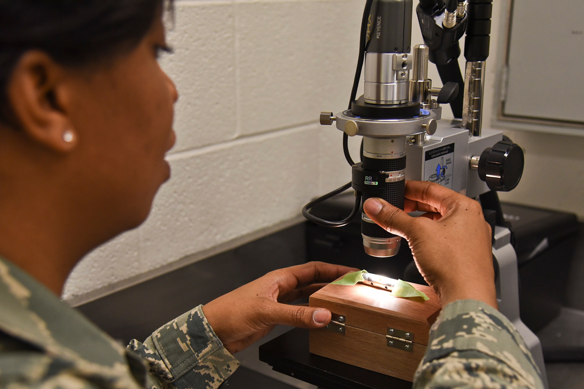 Tech. Sgt. Natasha Washington, 92nd Maintenance Squadron nondestructive inspection shop NCO in charge, adjusts the zoom on the newest piece of equipment in the NDI shop April 25, 2016 at Fairchild Air Force Base, Wash. The digital microscope has a high-resolution, 2.11 million pixel compact camera that allows Airmen to zoom in, measure and view fractures and cracks on various aircraft parts. (U.S. Air Force photo/Airman 1st Class Mackenzie Richardson)