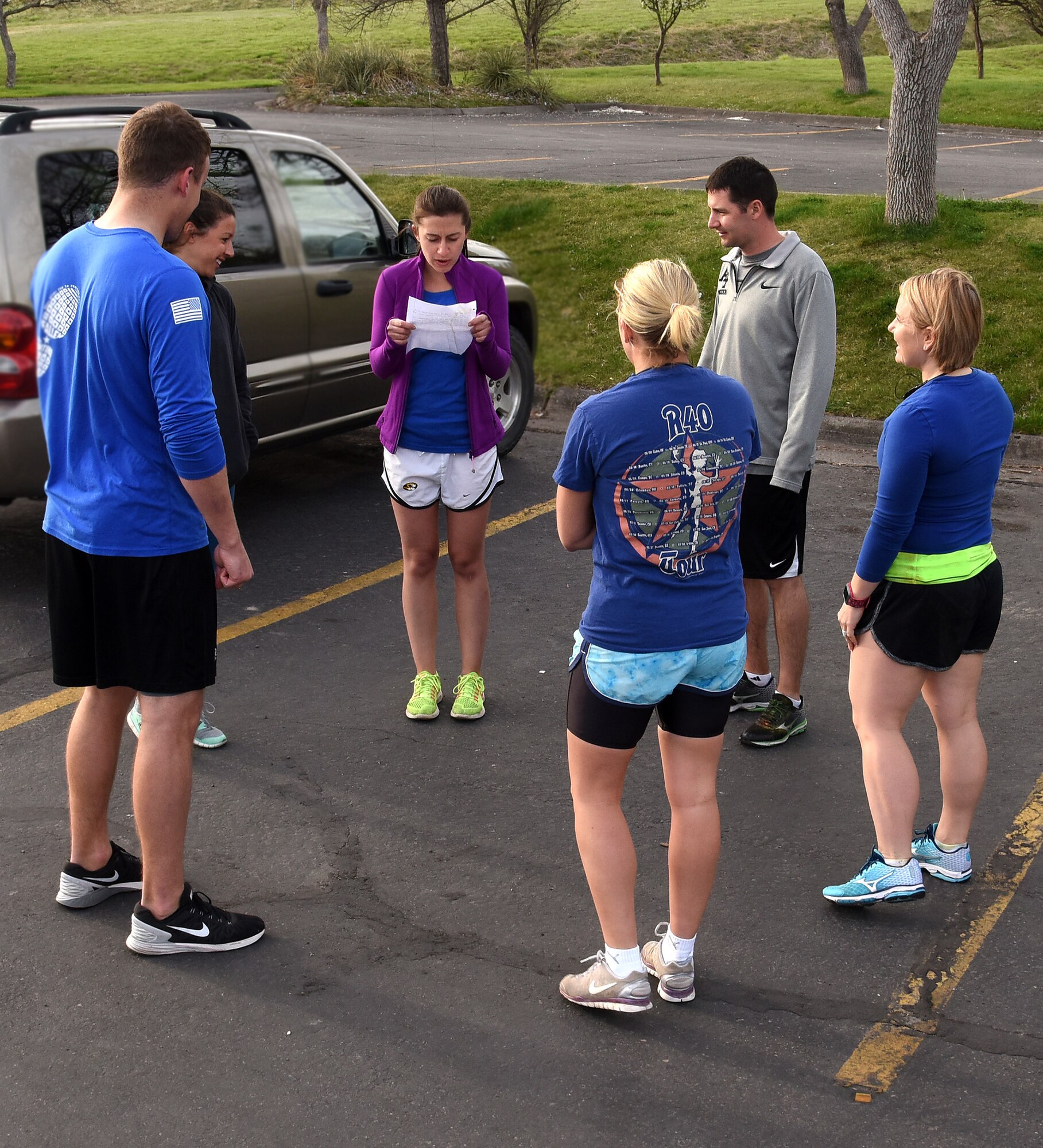 Members of the Wear Blue to Remember team gather for a moment of silence before a run April 23, 2016, at Giant Springs State Park in Great Falls, Mont. The running club meets every Saturday at 8 a.m. to run in honor of those military members who have sacrificed their lives. (U.S. Air Force photo/Senior Airman Jaeda Tookes)

