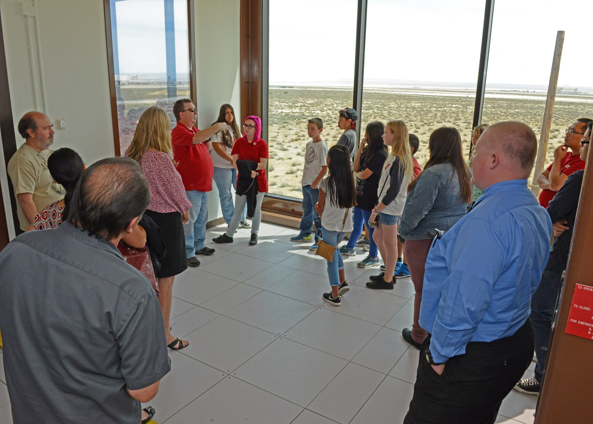 Students from local schools get to look out the observation area on the third floor of the Integrated Facility for Avionics Systems Test. The International Test and Evaluation Association's local Antelope Valley chapter held its annual grant luncheon there where seven school clubs received grants to further advance their programs. (U.S. Air Force photo by Kenji Thuloweit)