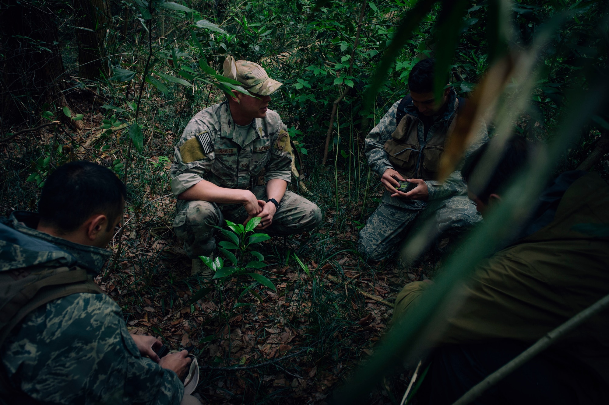 Participants in the Survival, Evasion, Resistance and Escape combat survival training, plan their first move at Tama Hills Recreation Area, Japan, April 21, 2016. The course is intended to teach aircrew members the basic principles of survival in a remote location. (U.S. Air Force photo by Senior Airman Delano Scott/Released)