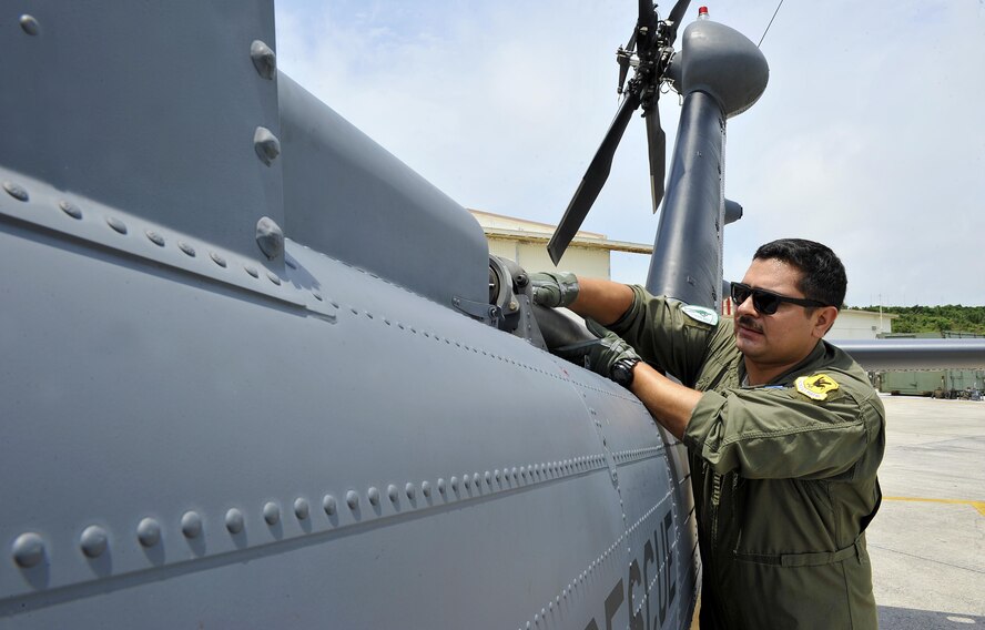 U.S. Air Force Senior Airman Ricardo Tinoco, 33rd Helicopter Maintenance Unit special mission aviator, inspects a tail shift of an HH-60G Pave Hawk helicopter during a pre-flight inspection, April 26, 2016, at Kadena Air Base, Japan. The preflight inspection consists of a thorough inspection of the entire aircraft to ensure its capability to perform the mission safely and effectively. (U.S. Air Force photo by Naoto Anazawa)