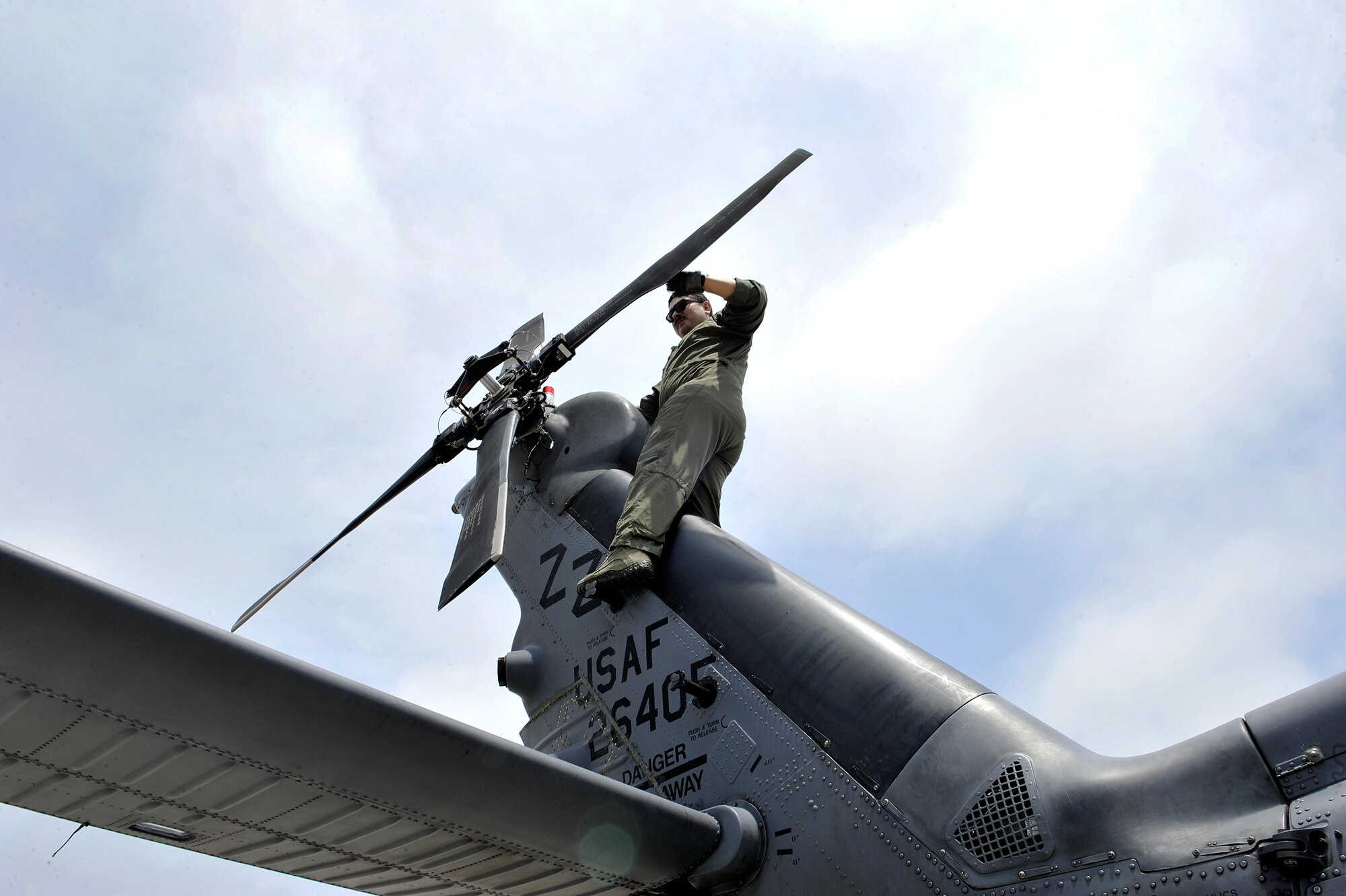 U.S. Air Force Senior Airman Ricardo Tinoco, 33rd Helicopter Maintenance Unit special mission aviator, inspects a propeller of an HH-60G Pave Hawk helicopter during a pre-flight inspection, April 26, 2016, at Kadena Air Base, Japan. The 33rd Rescue Squadron is a combat-ready HH-60G Pave Hawk squadron whose mission is search, rescue and recovery, night or day, over land or water. (U.S. Air Force photo by Naoto Anazawa)