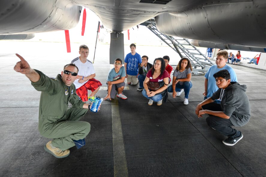 Capt. Brenden Wetzbarger, 44th Fighter Squadron pilot, shows Kadena Middle School students the bottom of an F-15 Eagle during a STEM-oriented field trip April 22, 2016, at Kaden Air Base, Japan. Fighter pilots explained how Science, Technology, Engineering and Math research has propelled a continuous stream of technical capabilities throughout the Air Force. (U.S. Air Force photo by Senior Airman John Linzmeier) 