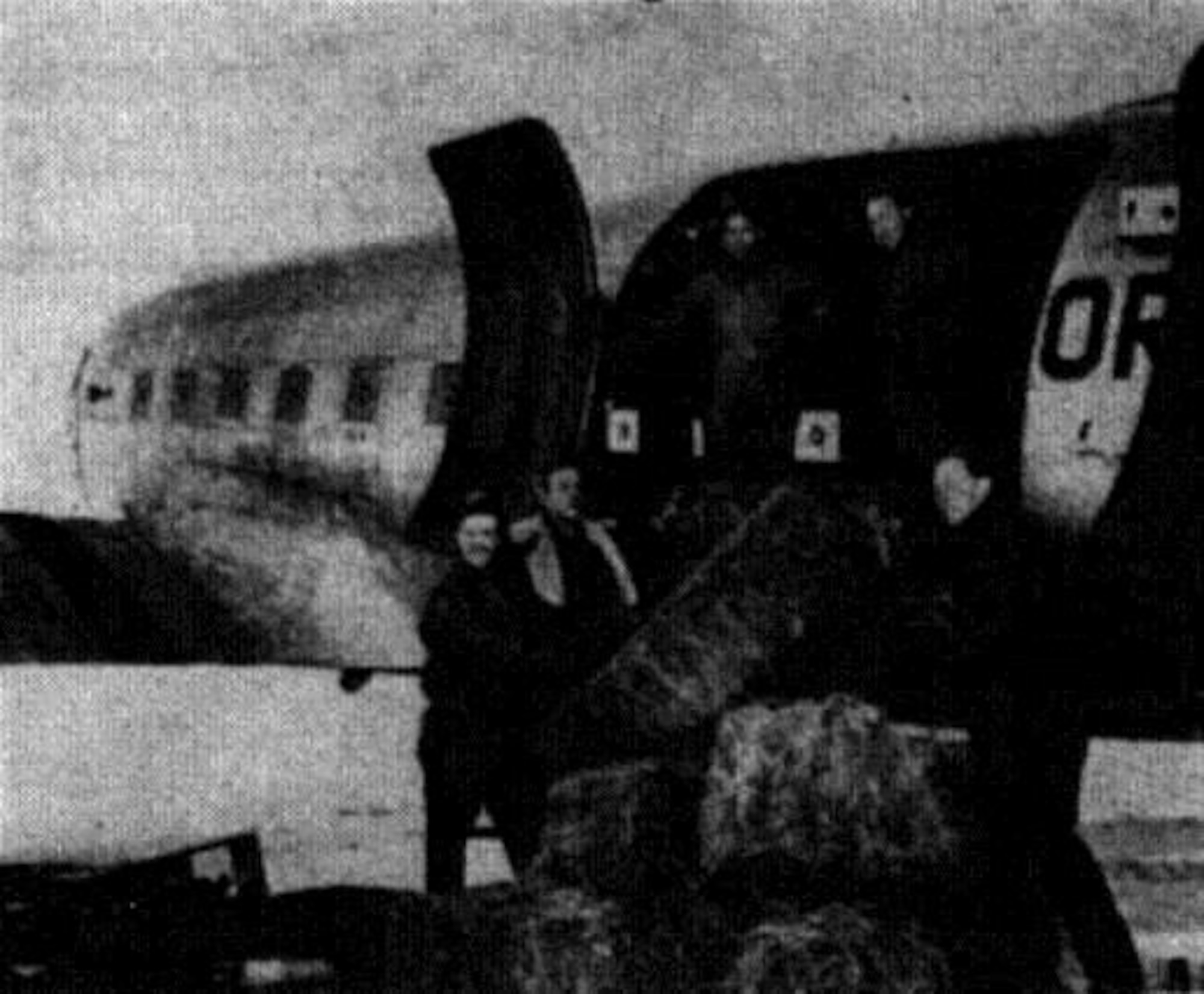 Haylift team members are shown loading hay aboard an OreANG C-47 at La Grande Airport in preparation for the 1 February 1949 mission.  Left to right:  District Game Agent Austin F. Hamer, Lt. Richard J. Schmidt, SSgt Chester Strauch, SSgt Verl Ward and Mr. John McKean, State Game Division Chief of Upland Game.  (Photo by Frank Schiro, courtesy La Grande Observer, via Eastern Oregon University Library)