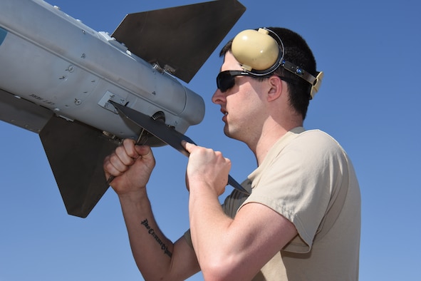 Senior Airman Elliot Snow, aircraft maintenance specialist with the 115th Fighter Wing in Madison, Wis. adjusts the fins of an AIM-120 Advanced Medium-Range Air-to-Air Missile (AMRAAM) at Nellis Air Force Base, Nev. April 5, 2016. The Wisconsin Air National Guard unit deployed more than 100 Airmen and eight F-16 Fighting Falcons for two weeks to support advanced training in weapons and tactics employment at the United States Air Force Weapons School. (U.S. Air National Guard photo by Master Sgt. Paul Gorman/Released)