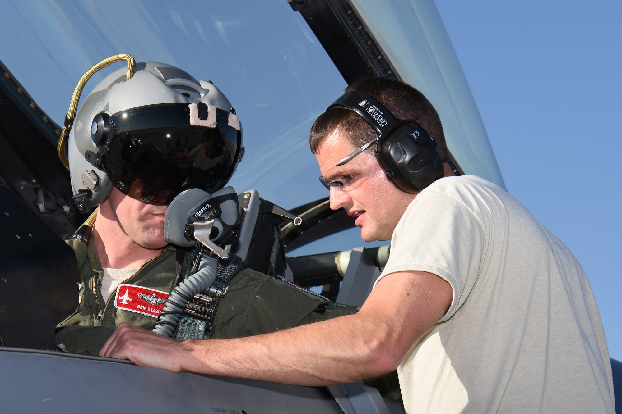 Master Sgt. Michael Lincoln, aircrew egress systems specialist for the 115th Fighter Wing in Madison, Wis., addresses canopy closure issues with Maj. Benjamin Staats, 115 FW pilot, on the aircraft ramp at Nellis Air Force Base, Nev., April 4, 2016. The Wisconsin Air National Guard unit deployed more than 100 Airmen and eight F-16 Fighting Falcons for two weeks to support advanced training in weapons and tactics employment at the United States Air Force Weapons School. (U.S. Air National Guard photo by Master Sgt. Paul Gorman/Released)