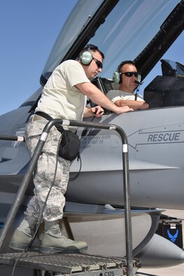 Technical sergeants Chad Boyd, left, and Douglas Linder, avionics systems specialists with the 115th Fighter Wing in Madison, Wis., perform avionics maintenance on an F-16 Fighting Falcon at Nellis Air Force Base, Nev., April 5, 2016. The Wisconsin Air National Guard unit deployed more than 100 Airmen and eight F-16 Fighting Falcons for two weeks to support advanced training in weapons and tactics employment at the United States Air Force Weapons School. (U.S. Air National Guard photo by Master Sgt. Paul Gorman/Released)