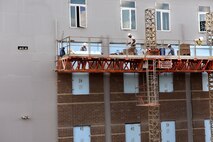 MCGHEE TYSON AIR NATIONAL GUARD BASE, Tenn. - Brick layers make progress on the east dormitory building wall of the multi-use facility under construction April 26, 2016, at the I.G. Brown Training and Education Center. (U.S. Air National Guard photo by Master Sgt. Mike R. Smith/Released)
