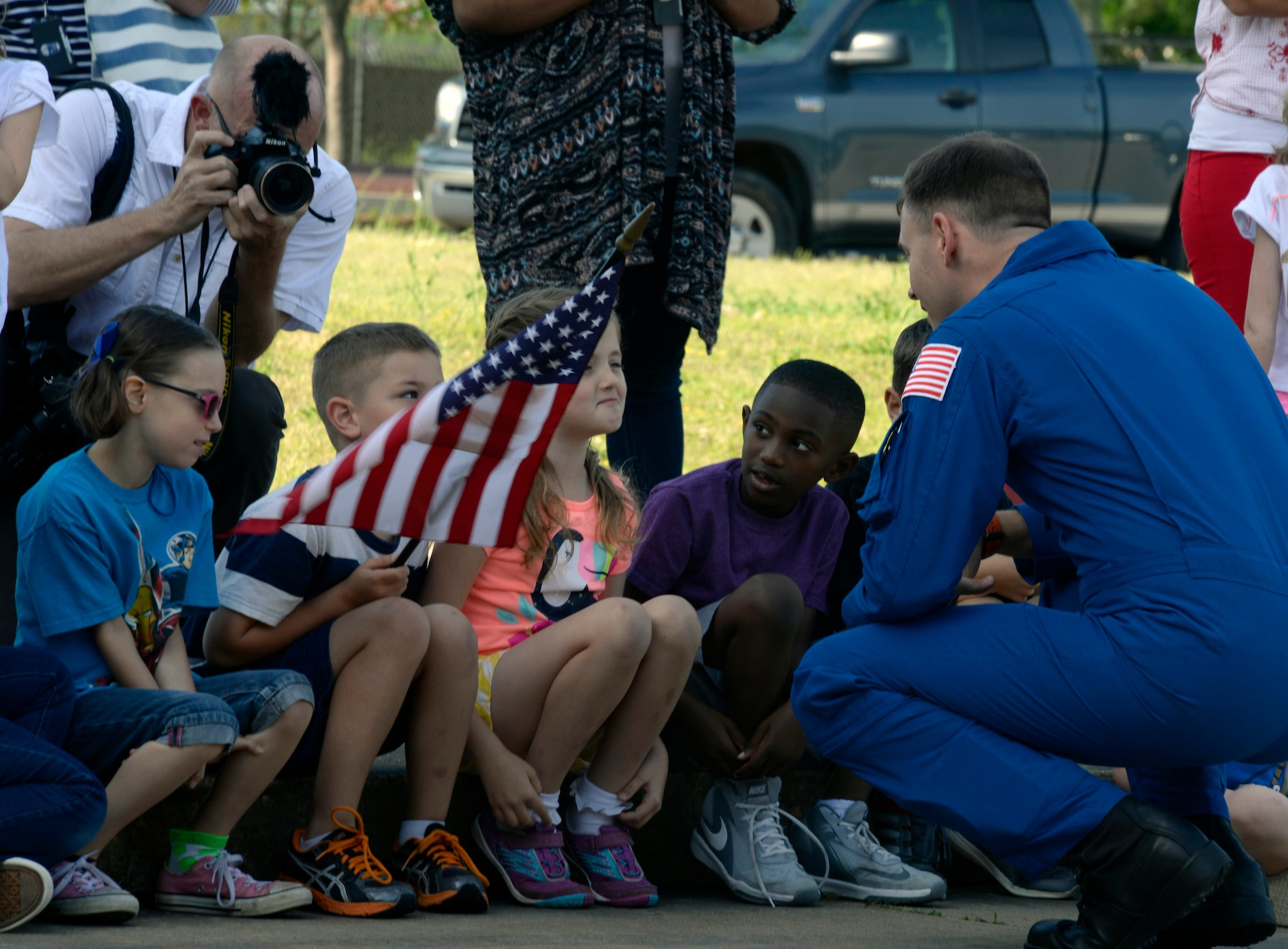 First grade students speak to Air Force Lt. Col. Tyler Hague, NASA astronaut, during his visit to Maxwell Elementary School on Maxwell Air Force Base, Ala., April 20, 2016. Hague visited the school to speak to a few of the students about how he became an astronaut and what difficulties astronauts face in space. (U.S. Air Force photo/Senior Airman Tammie Ramsouer)