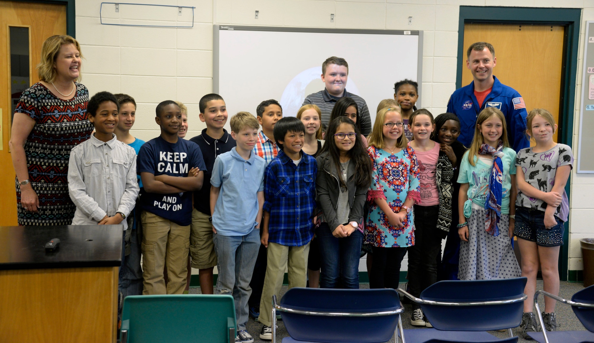 Kristine Karter’s fifth grade class poses for a photo with Air Force Lt. Col. Tyler Hague, NASA astronaut, during his visit to Maxwell Elementary School, April 20, 2016. Students from Karter’s class wrote letters to NASA asking to have the opportunity to speak to an actual astronaut. (U.S. Air Force photo/Senior Airman Tammie Ramsouer)