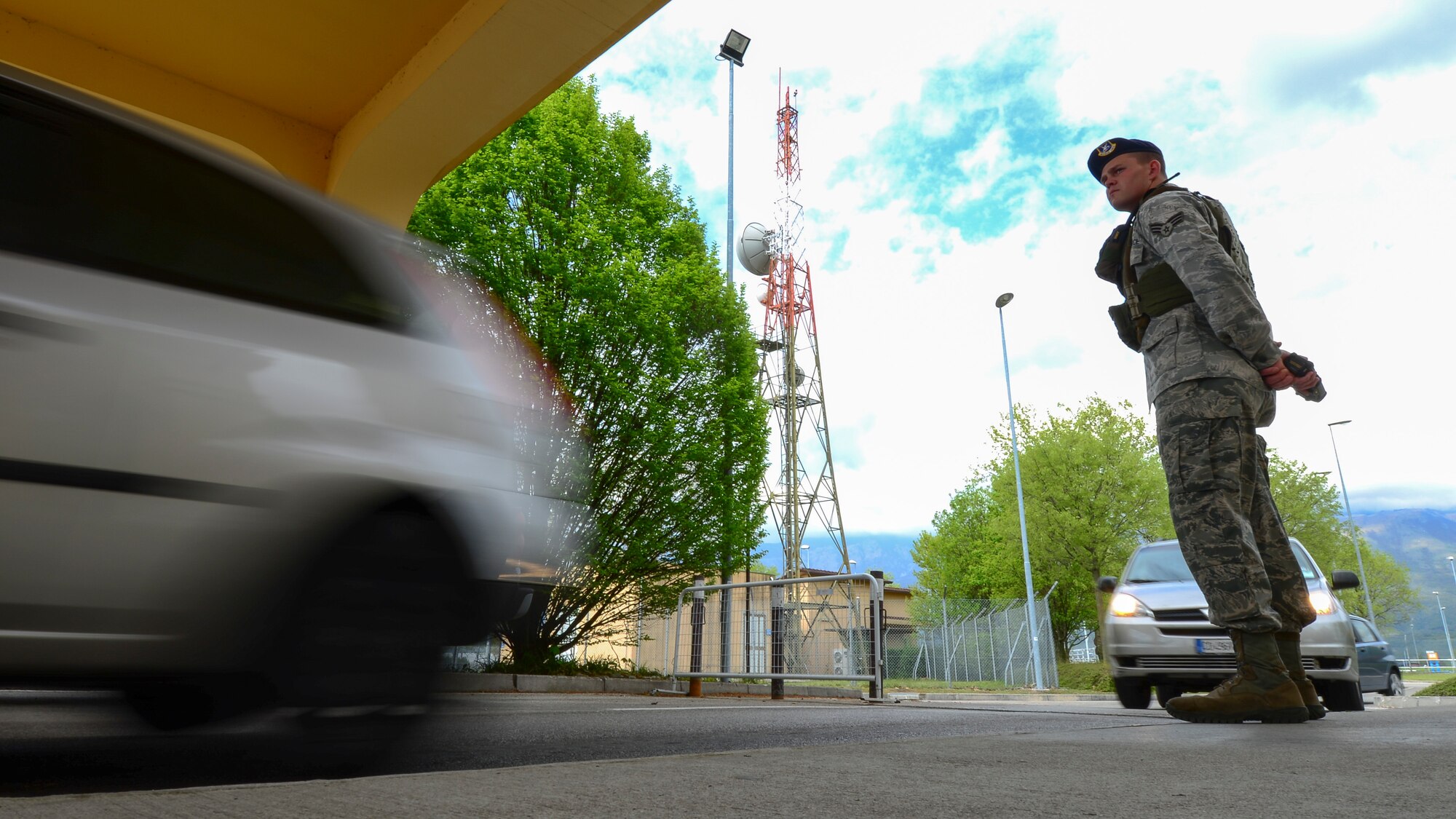 Senior Airman Matthew Yoder, 31st Security Forces Squadron monitoring facility operator, stands guard during his shift at a gate, April 15, 2016, at Aviano Air Base, Italy. Defenders can check all personal identification cards used to gain access the base. (U.S. Air Force photo by Airman 1st Class Cory W. Bush/Released)