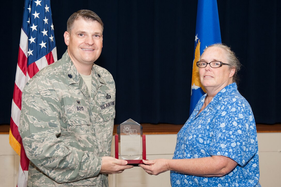 Lt. Col. Aaron Boyd, 45th Contracting Squadron commander, presents Kathy Jackson the Air Force Space Command’s award for Secretary of the Air Force Professionalism in Contracting March 29 during the squadron’s Commander’s Call at Patrick Air Force Base, Florida. (U.S. Air Force photo by Benjamin Thacker/Released)
