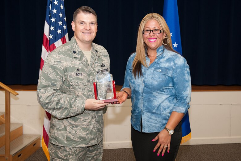 Lt. Col. Aaron Boyd, 45th Contracting Squadron commander, presents Kyra Jackson the Air Force Space Command Outstanding Pricing award March 29 during the squadron’s Commander’s Call at Patrick Air Force Base, Florida. (U.S. Air Force photo by Benjamin Thacker/Released)
