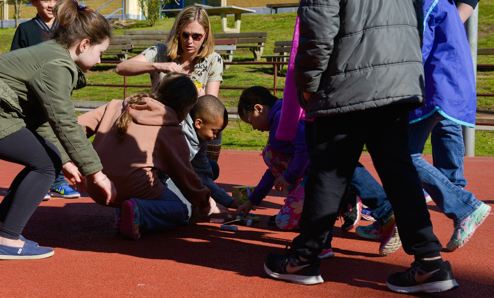 Children from Vogelweh Elementary School flock to grab chalk as they begin their therapy session April 21, 2016, at Vogelweh Air Base, Germany. The students go through therapy at school as they cope with being suddenly separated from family that is serving in Turkey. (U.S. Air force photo/Airman 1st Class Lane T. Plummer)