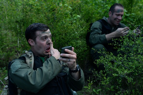 U.S. Air Force Capt. Jon Clausen, 61st Airlift Squadron pilot, camouflages his face during Green Flag 16-06, April 22, 2016, near Ft. Polk, La. The C-130J aircrew used survival, evasion, resistance and escape skills in order to reach an appointed location to be recovered during the exercise. (U.S. Air Force photo by Airman 1st Class Mercedes Taylor)