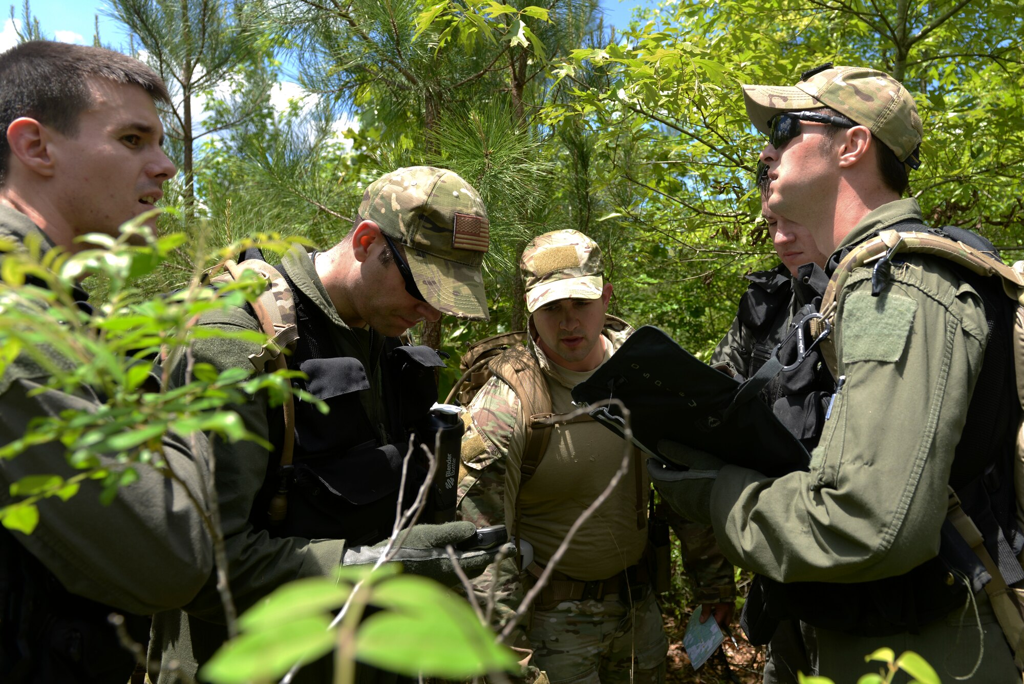 U.S. Air Force Airmen review a topographic map during a survival, evasion, resistance and escape exercise April 22, 2016, near Ft. Polk, La. The C-130J aircrew recovered airdropped supplies while awaiting rescue by U.S. service members. (U.S. Air Force photo by Airman 1st Class Mercedes Taylor) 